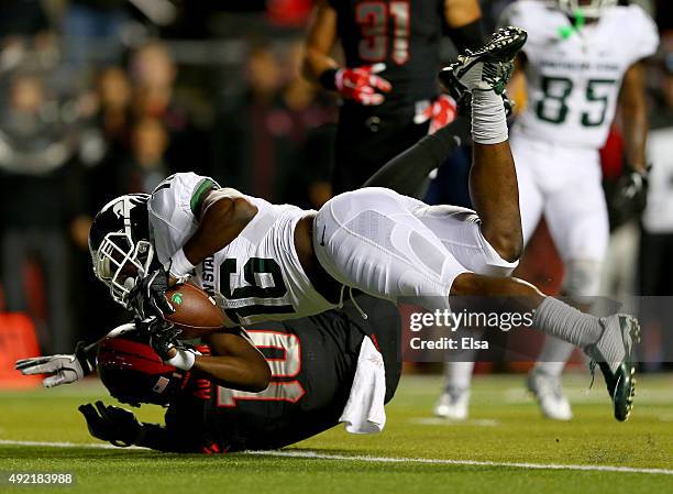 Aaron Burbridge of the Michigan State Spartans makes the catch as Blessuan Austin of the Rutgers Scarlet Knights defends on October 10, 2015 at High...