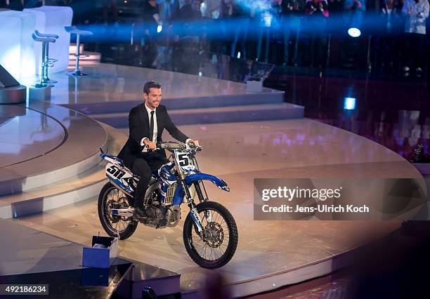 Florian Silbereisen rides a motorbike during the tv show '150 Jahre Schlager - Das Grosse Fest Zum Jubilaeum' at Messe Erfurt on October 10, 2015 in...