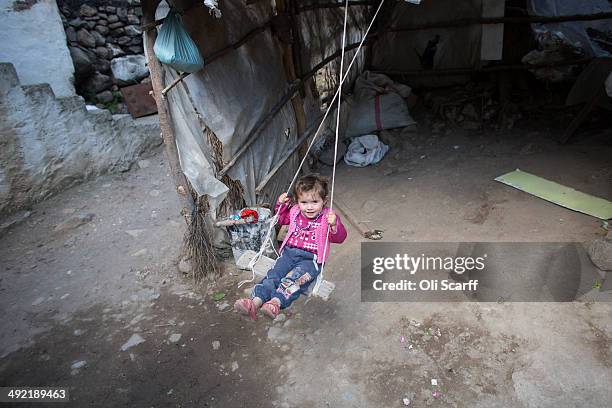 The daughter of miner Bilal Ay, who died in the explosion at Soma mine, plays on a swing at their home in the hamlet of Elmadere close to the mine...