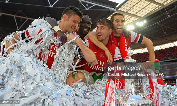 Olivier Giroud, Bacary Sagna, Aaron Ramsey and Mathieu Flamini celebrate after the FA Cup with Budweiser Final match between Arsenal and Hull City at...