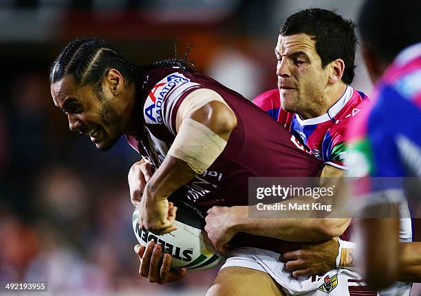 Steve Matai of the Sea Eagles is tackled during the round 10 NRL match between the Manly-Warringah Sea Eagles and the Newcastle Knights at Brookvale...
