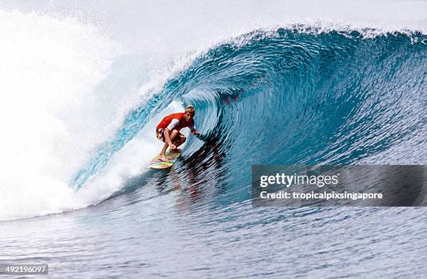 surfing in the mentawai islands. - mentawai islands stock pictures, royalty-free photos & images