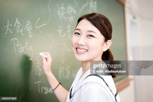 female student writing happy words, chinese and english, hong kong - multilingual stock pictures, royalty-free photos & images