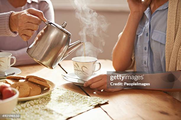 life is like a tea cup - young woman with grandmother stockfoto's en -beelden