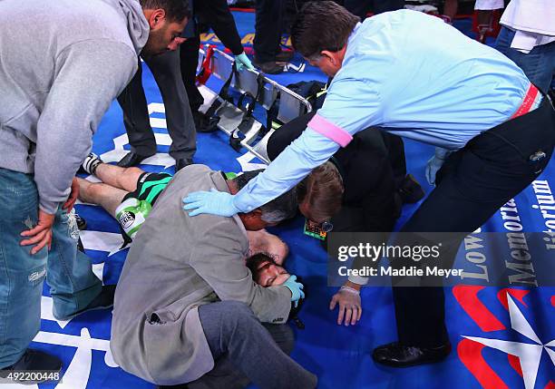 Danny O'Connor is tended to after being knocked out by Gabriel Bracero during their Welterweight bout on October 10, 2015 at Lowell Memorial...