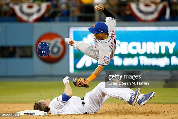 Ruben Tejada of the New York Mets is hit by a slide by Chase Utley of the Los Angeles Dodgers in the seventh inning in an attempt to turn a double...