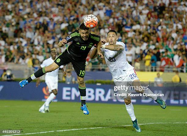 Oribe Peralta of Mexico heads the ball past Geoff Cameron of the United States during the first half of the 2017 FIFA Confederations Cup Qualifier at...