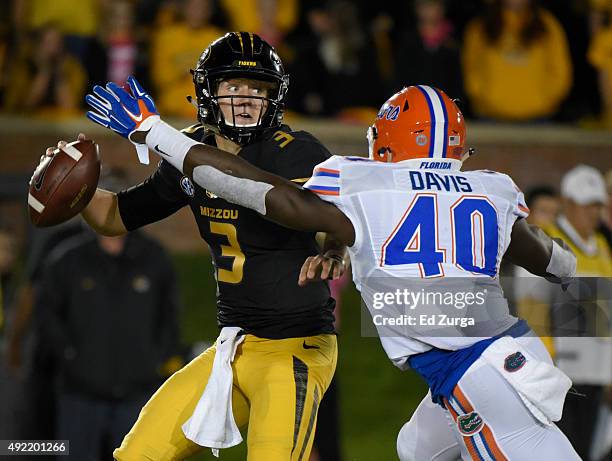 Quarterback Drew Lock of the Missouri Tigers avoids a sack by linebacker Jarrad Davis of the Florida Gators in the third quarter at Memorial Stadium...