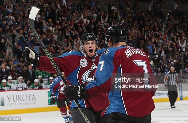 Jack Skille of the Colorado Avalanche celebrates with John Mitchell after Mitchell's goal against the Dallas Stars at the Pepsi Center on October 10,...