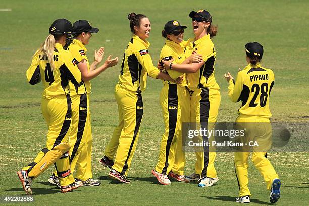 Nicole Bolton of Western Australia is congratulted by team mates after the runout of Sarah Taylor of South Australia during the round one WNCL match...