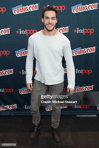 Actor Chris Wood poses in the press room for the "Containment" panel during New York Comic-Con Day 3 at The Jacob K. Javits Convention Center on...