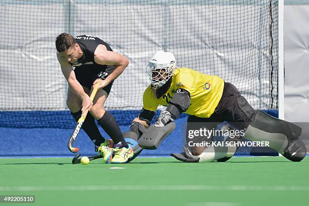 Nick Wilson of New Zealand controls the ball from Harjot Singh of India during the penalty shootout following the international men's hockey test...