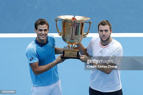 Vasek Pospisil of Canada and Jack Sock of the United States pose with their trophy after winning the Mens's doubles final match against Daniel Nestor...