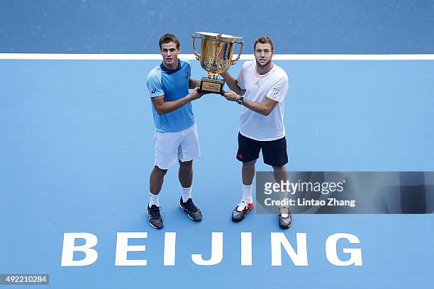 Vasek Pospisil of Canada and Jack Sock of the United States pose with their trophy after winning the Mens's doubles final match against Daniel Nestor...