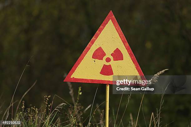 Sign warns of radiation at the site of Kopachi village located inside the Chernobyl Exclusion Zone on September 29, 2015 near Chornobyl, Ukraine....