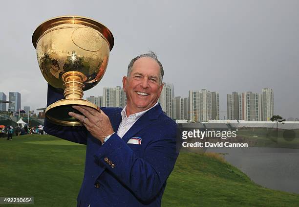 Captain Jay Haas of the United States Team poses with the Presidents Cup after the United States defeated the International Team 15.5 to 14.5 after...