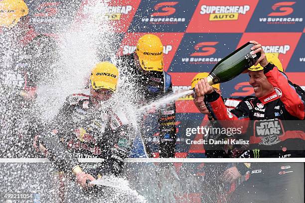 Craig Lowndes driver of the Red Bull Racing Holden VF Commodore and Warren Luff driver of the Holden Racing Team Holden VF Commodore celebrate on the...