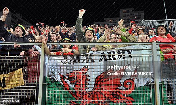 Wales' supporters wave after the Euro 2016 qualifying football match between Bosnia and Herzegovina and Wales, in Zenica, on October 10, 2015. The...