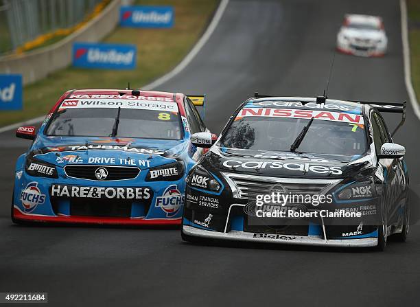 Todd Kelly driving the Nissan Motorsport Nissan battles for position with Jason Bright driving the Team BOC Holden during the Bathurst 1000, which is...