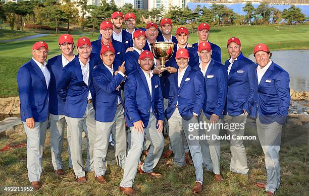 The United States team pose with the Presidents Cup after their 15.5 to 14.5 win during the Sunday singles matches in the 2015 Presidents Cup at the...