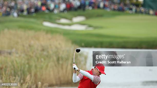Zach Johnson of the United States Team hits his tee shot on the 14th hole during the Sunday singles matches at The Presidents Cup at Jack Nicklaus...
