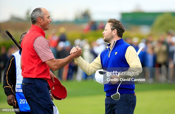 Branden Grace of South Africa and the International team shakes hands with Matt Kuchar of the United States after he had beaten Kuchar by 2&1 during...