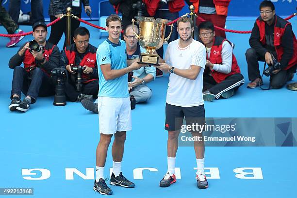 Vasek Pospisil of Canada and Jack Sock of the United States pose with their trophy after winning the Mens's doubles final match against Daniel Nestor...