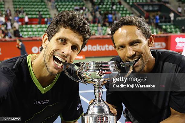 Raven Klaasen of South Africa and Marcelo Melo of Brazil celebrate with the trophy after winning the men's doubles final match against Juan Sebastian...