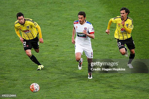 Mateo Poljak of the Jets competes for the ball with Blake Powell and Albert Riera of the Phoenix during the round one A-League match between the...