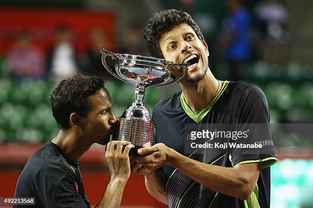 Raven Klaasen of South Africa and Marcelo Melo of Brazil celebrate with the trophy after winning the men's doubles final match against Juan Sebastian...