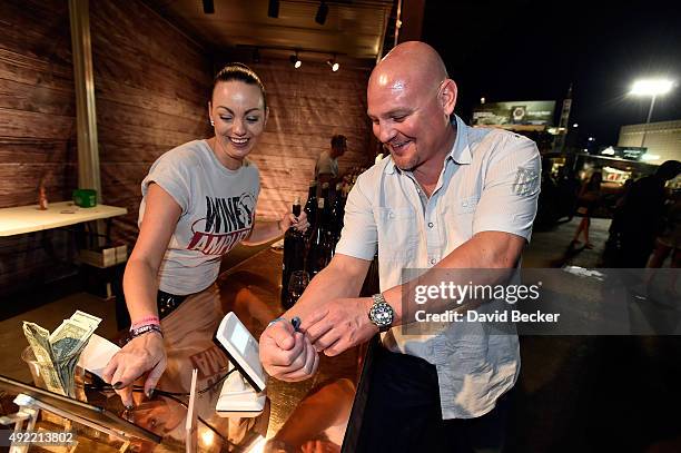 Guest uses a RFID embedded wristband to make a purchase at the 10th annual Wine Amplified festival at the Las Vegas Village on October 10, 2015 in...