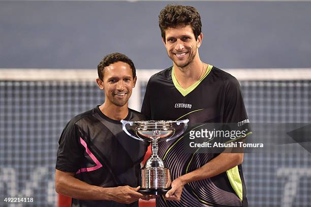 Raven Klaasen of South Africa and Marcelo Melo of Brazil celebrate with the trophy after winning the men's doubles final match against Juan Sebastian...