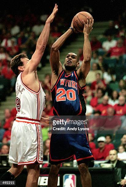 Allan Houston of the New York Knicks shoots the ball while Dan Majerle of the Miami Heat tries to defend him during the first round play offs at the...