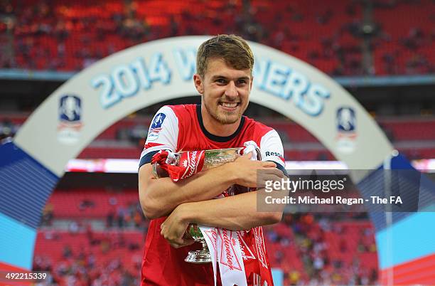 Aaron Ramsey of Arsenal poses with the trophy after the FA Cup with Budweiser Final match between Arsenal and Hull City at Wembley Stadium on May 17,...