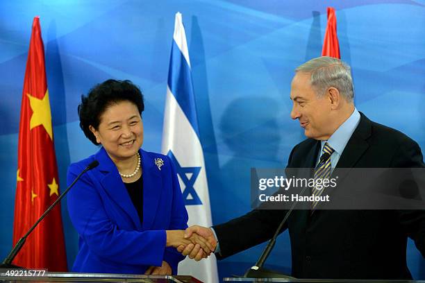 In this handout provided by the Israeli Government Press Office, Prime Minister of Israel, Benjamin Netanyahu greets Chinese Vice Prime Minister Liu...
