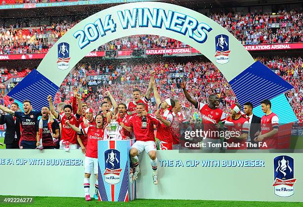 Arsenal players celebrate with the trophy during the FA Cup with Budweiser Final match between Arsenal and Hull City at Wembley Stadium on May 17,...