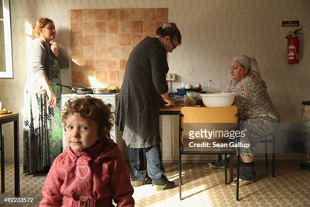 Chechen asylum-applicants Asya Sugaipova , Mohza Mukayeva and Khadra Zhukova prepare potatoe piroshki and other foods as Sugaipova's daughter Irsana...