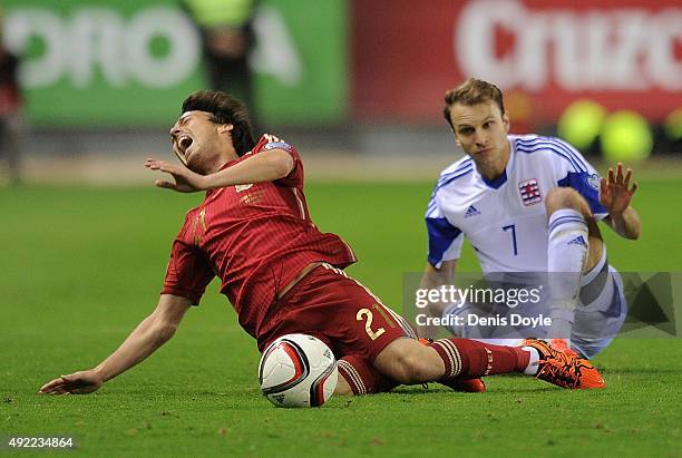 David Silva of Spain is fouled by Lars Gerson of Luxembourg during the UEFA EURO 2016 Qualifier group C match between Spain and Luxembourg at Estadio...