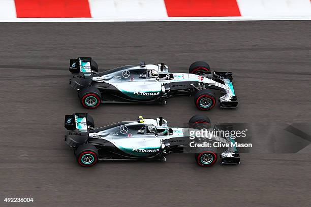 Lewis Hamilton of Great Britain and Mercedes GP and Nico Rosberg of Germany and Mercedes GP race into the first corner during the Formula One Grand...