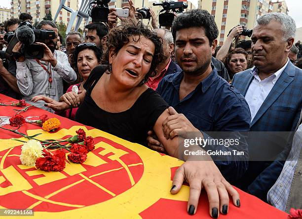 Family members of Korkmaz Tedik, a victim of Saturday's bomb blasts, mourn over his coffin during a funeral ceremony in Ankara, October 11, 2015...