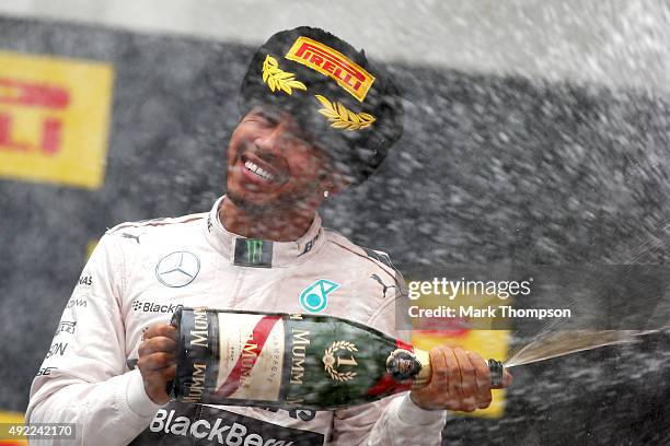 Lewis Hamilton of Great Britain and Mercedes GP celebrates on the podium after winning the Formula One Grand Prix of Russia at Sochi Autodrom on...