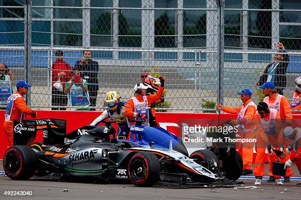 Marcus Ericsson of Sweden and Sauber F1 and Nico Hulkenberg of Germany and Force India get out of their cars after colliding during the Formula One...