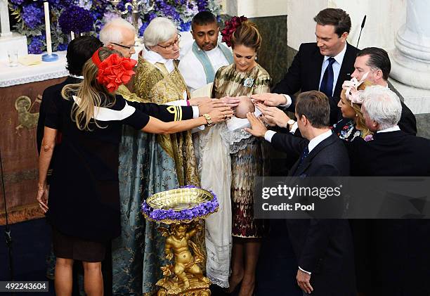 Prince Nicolas of Sween is christened at Drottningholm Palace as Princess Madeleine of Sweden, holding Princess Leonore, and Christopher O'Neill look...