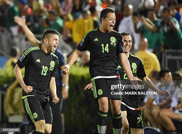 Oribe Peralta of Mexico celebrates with teammates Javier Hernández and Paul Aguilar after scoring a goal during their 2015 CONCACAF Cup game against...
