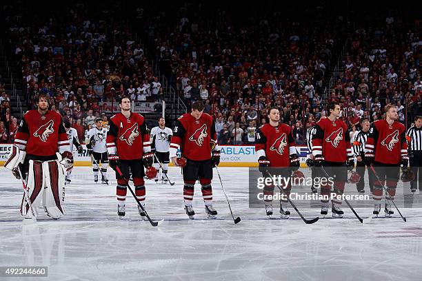 Goaltender Mike Smith, Oliver Ekman-Larsson, Michael Stone, Max Domi, Antoine Vermette and Mikkel Boedker of the Arizona Coyotes stand attended for...