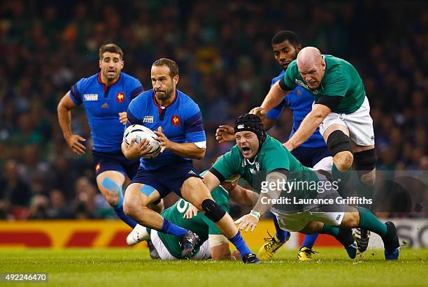 Frederic Michalak of France evades a challenge from Mike Ross of Ireland during the 2015 Rugby World Cup Pool D match between France and Ireland at...