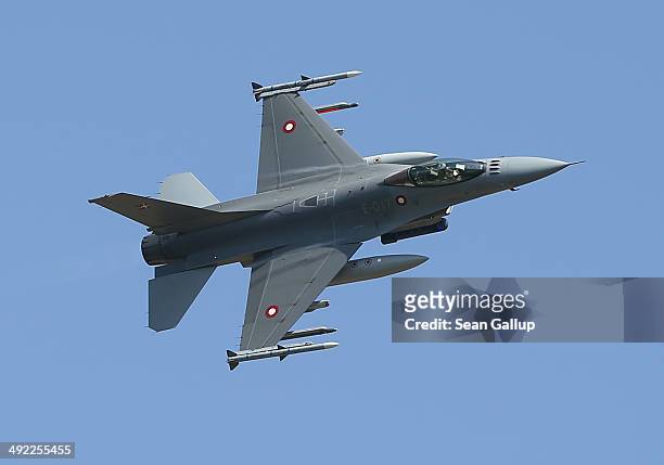 An F-16 fighter plane of the Royal Danish Air Force simulates an attack during a demonstration while participating in the NATO "Spring Storm"...