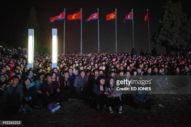 Spectators watch an open air dance and music performance on the North bank of the Taedong river in Pyongyang on October 11, 2015. North Korea is...