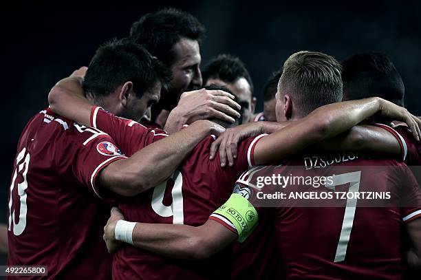 Hungary's Krisztian Nemeth celebrates with teammates after scoring a goal during the UEFA Euro 2016 qualifying Group F football match between Greece...