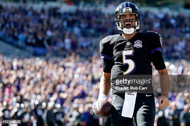 Quarterback Joe Flacco of the Baltimore Ravens celebrates after scoring a first quarter touchdown during a game against the Cleveland Browns at M&T...